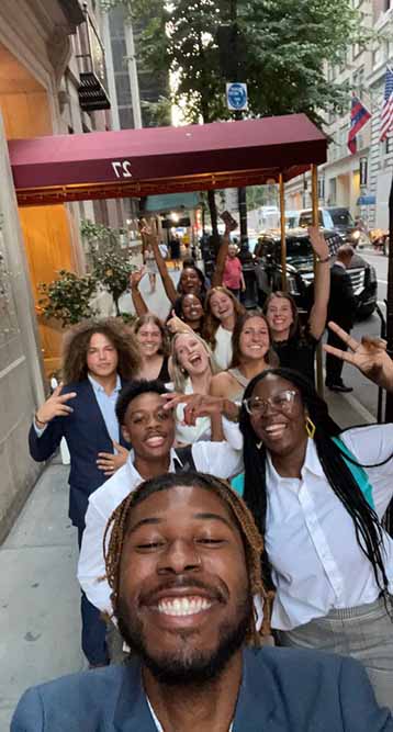 The students take a group selfie while walking the streets of New York.