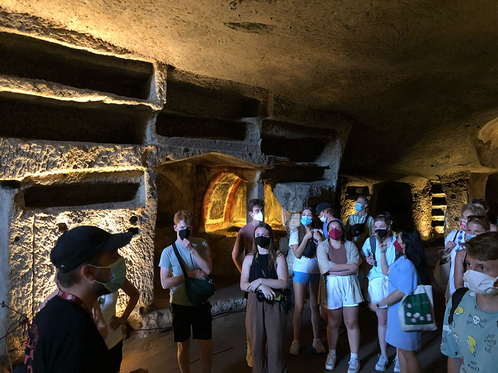 Group inside old structure with yellow light glow.