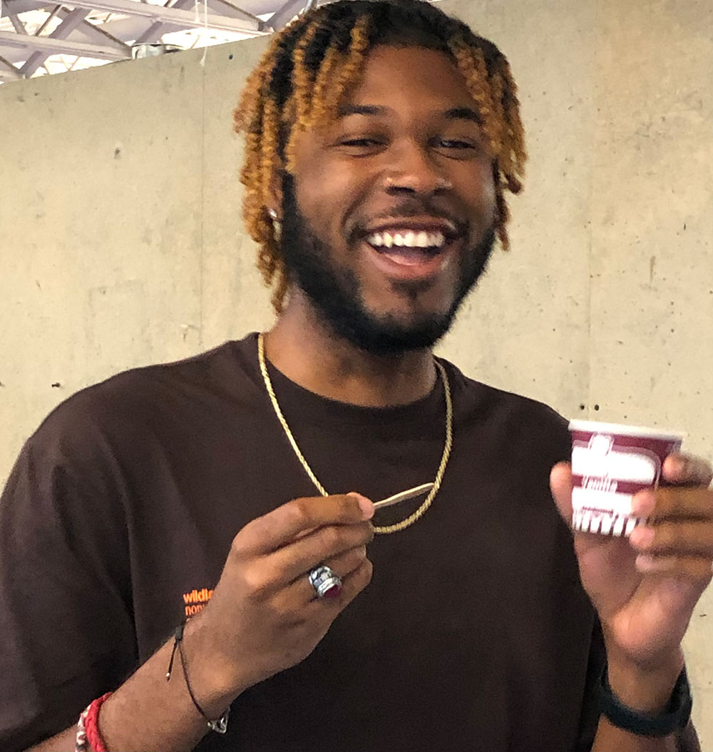 student smiles eating his ice cream