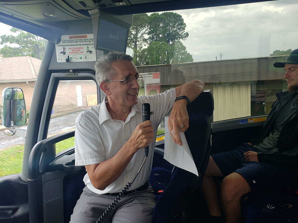 David Perkes talks to students and faculty with the MSU Coastal Studio on a bus microphone