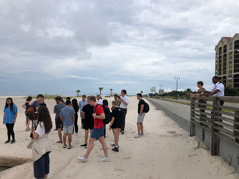 Students and faculty with the MSU Coastal Studio conduct research on a beach for their interdisciplinary design studio