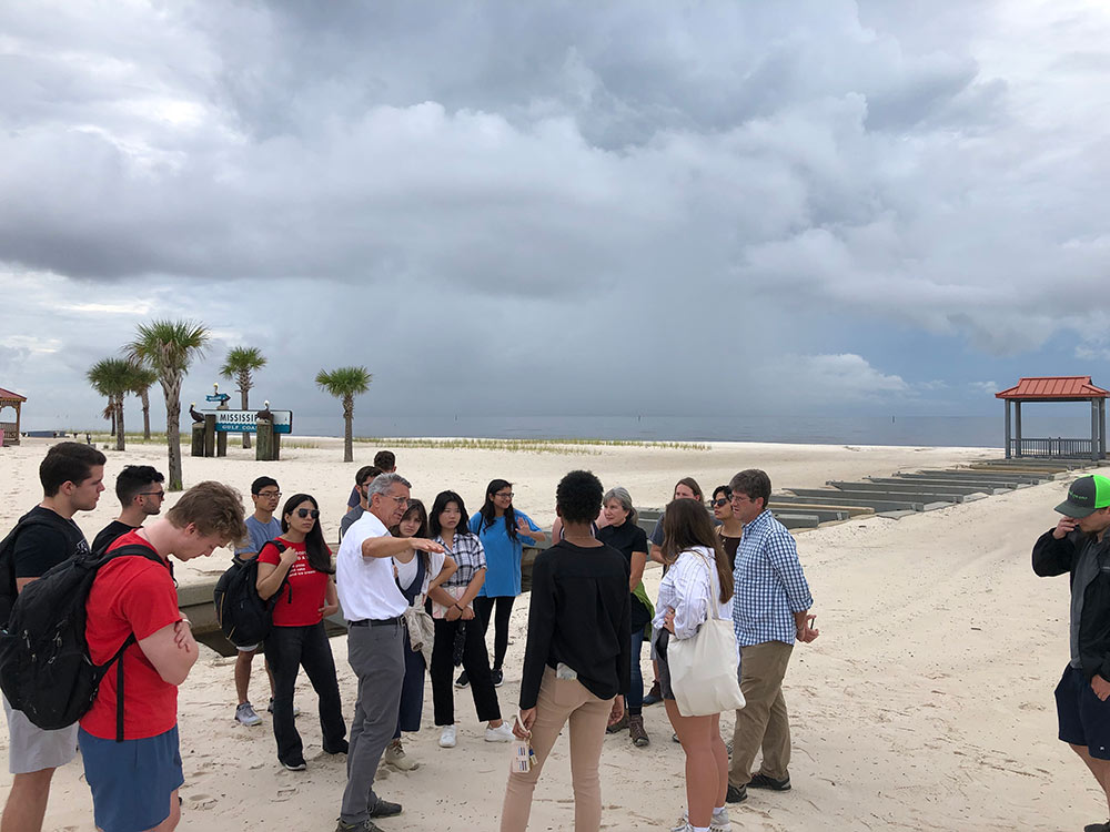 Students and faculty with the MSU Coastal Studio conduct research on a beach for their interdisciplinary design studio