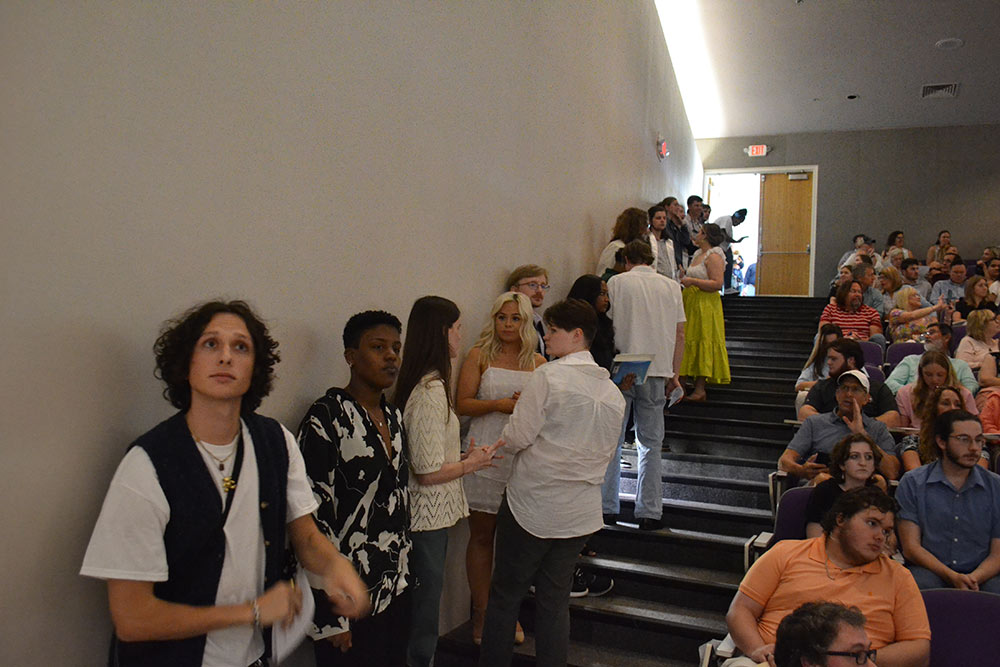 Class of 2023 architecture students line staircase of the Robert and Freda Harrison auditorium