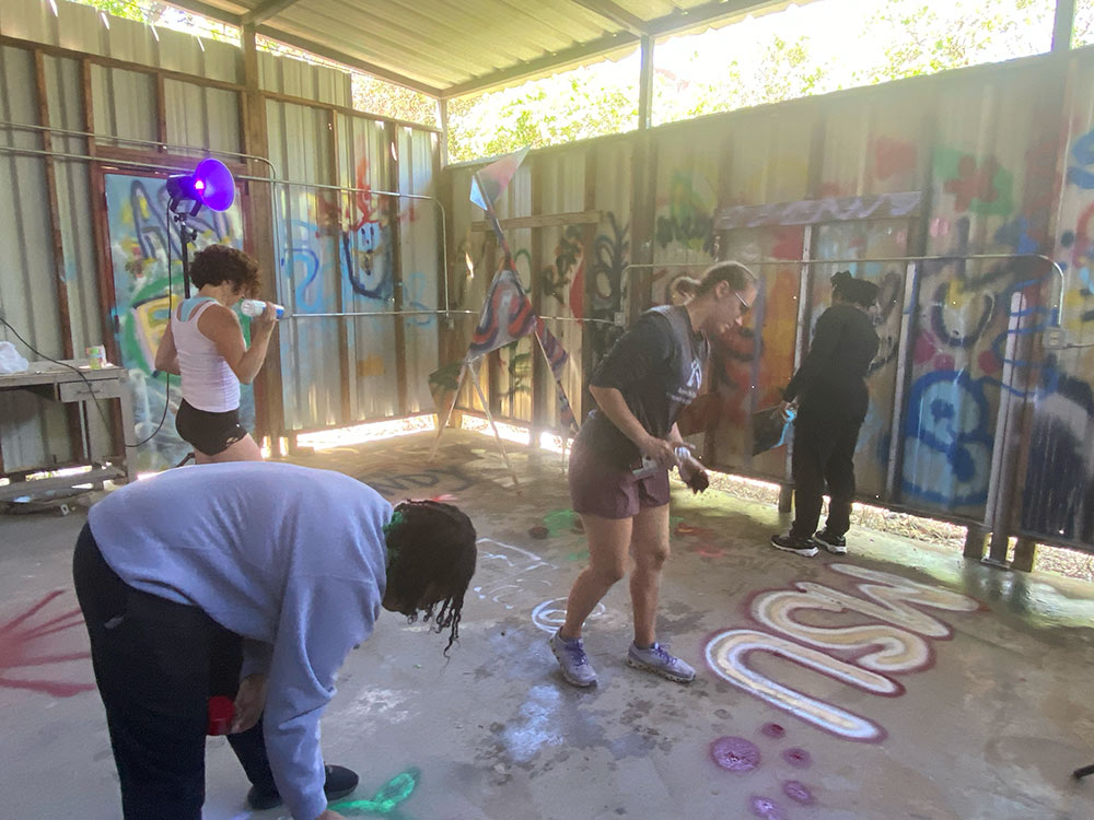 CAAD students and staff spray paint at decompression event