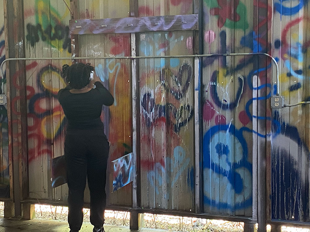 CAAD student spray paints at decompression event
