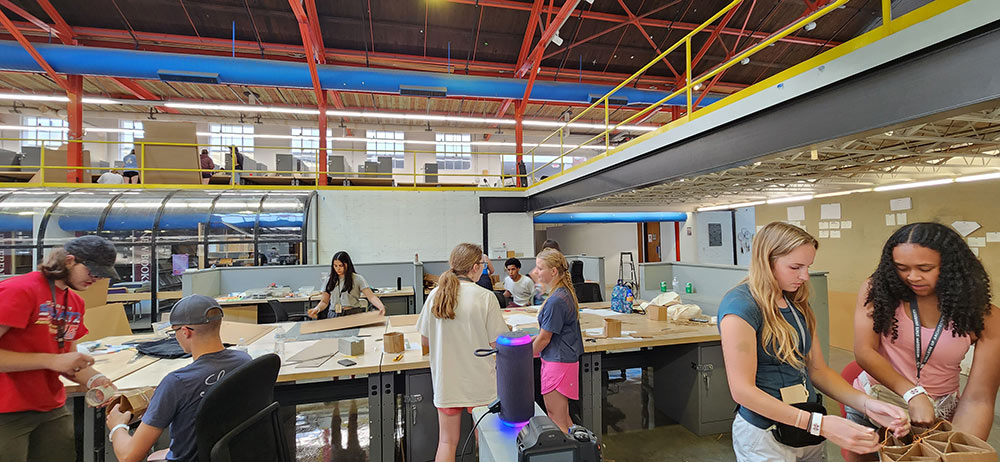 View of a few desks full of Design Discovery campers working on their projects in Barn.