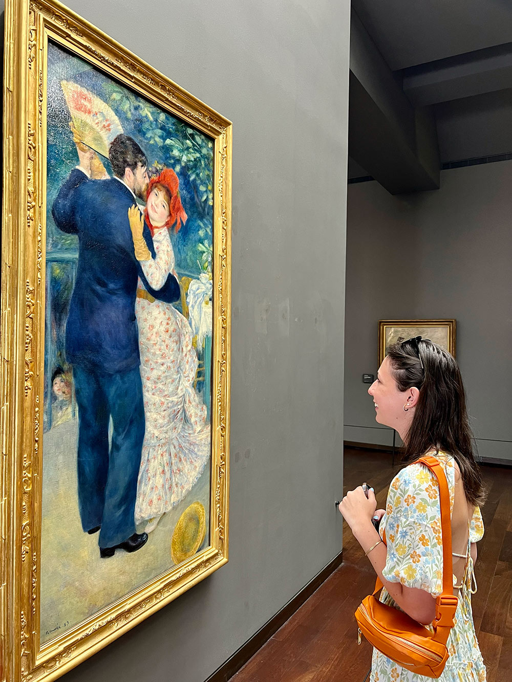 Art student Katherine Nause viewing a painting by the artist Renoir at the Musée d’Orsay in Paris, France.