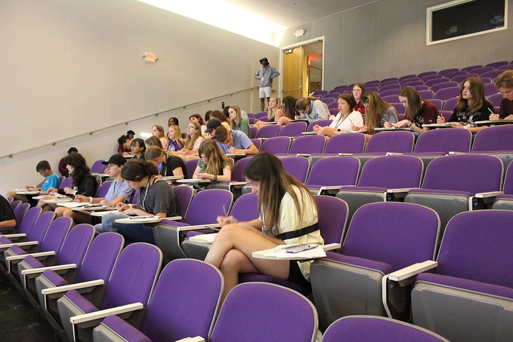 View of full auditorium while Design Discovery campers take notes during a presentation