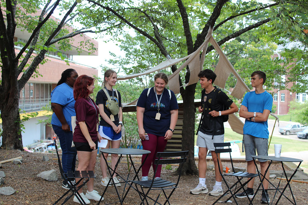 Group of Design Discovery campers conversing by their instant environment project.