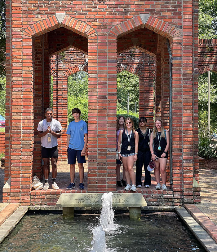 Group of Design Discovery campers pose for a photo in the courtyard of the Chapel of Memories.