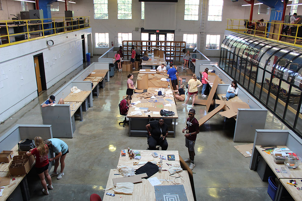 View of Barn full of Design Discovery campers working on their cardboard chair projects