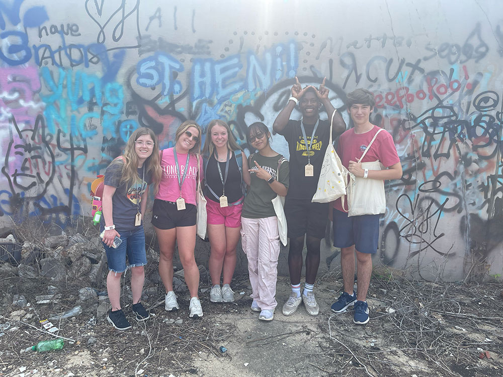 Design Discovery campers posing in front of graffiti art.