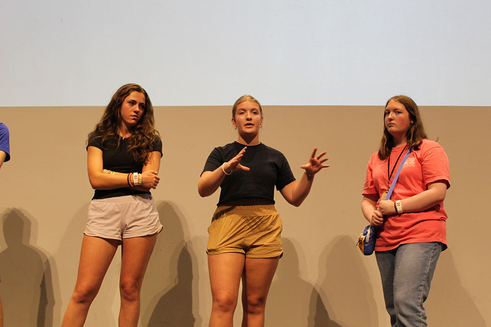 A group of Design Discovery campers presenting in the auditorium.