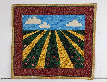 Fabric depiction of a strawberry field.