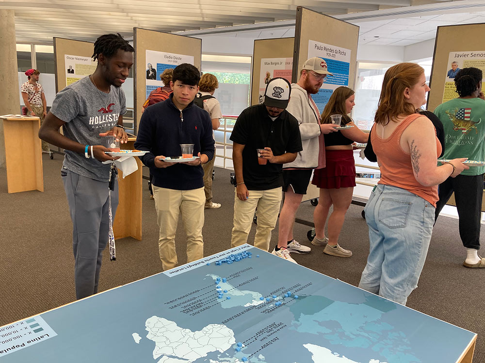 Groups of students interacting with a map and its pieces.