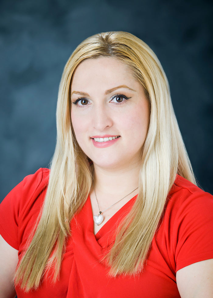 headshot of Ramona Spencer wearing red