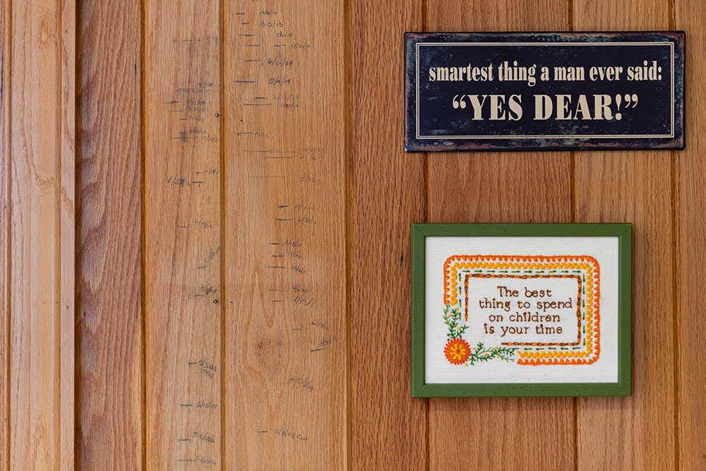 wall showing to framed quotes: "smartest thing a man ever said: Yes, Dear!" and "the best thing to spend on children is your time"