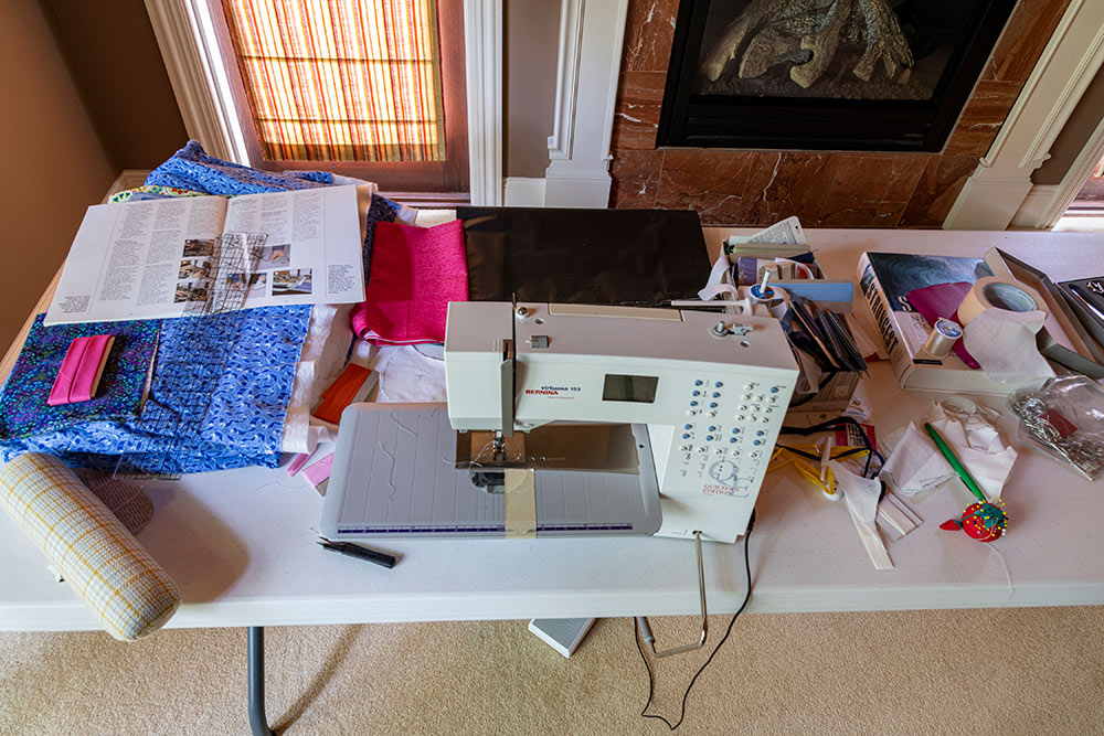 table with sewing machine and supplies on it