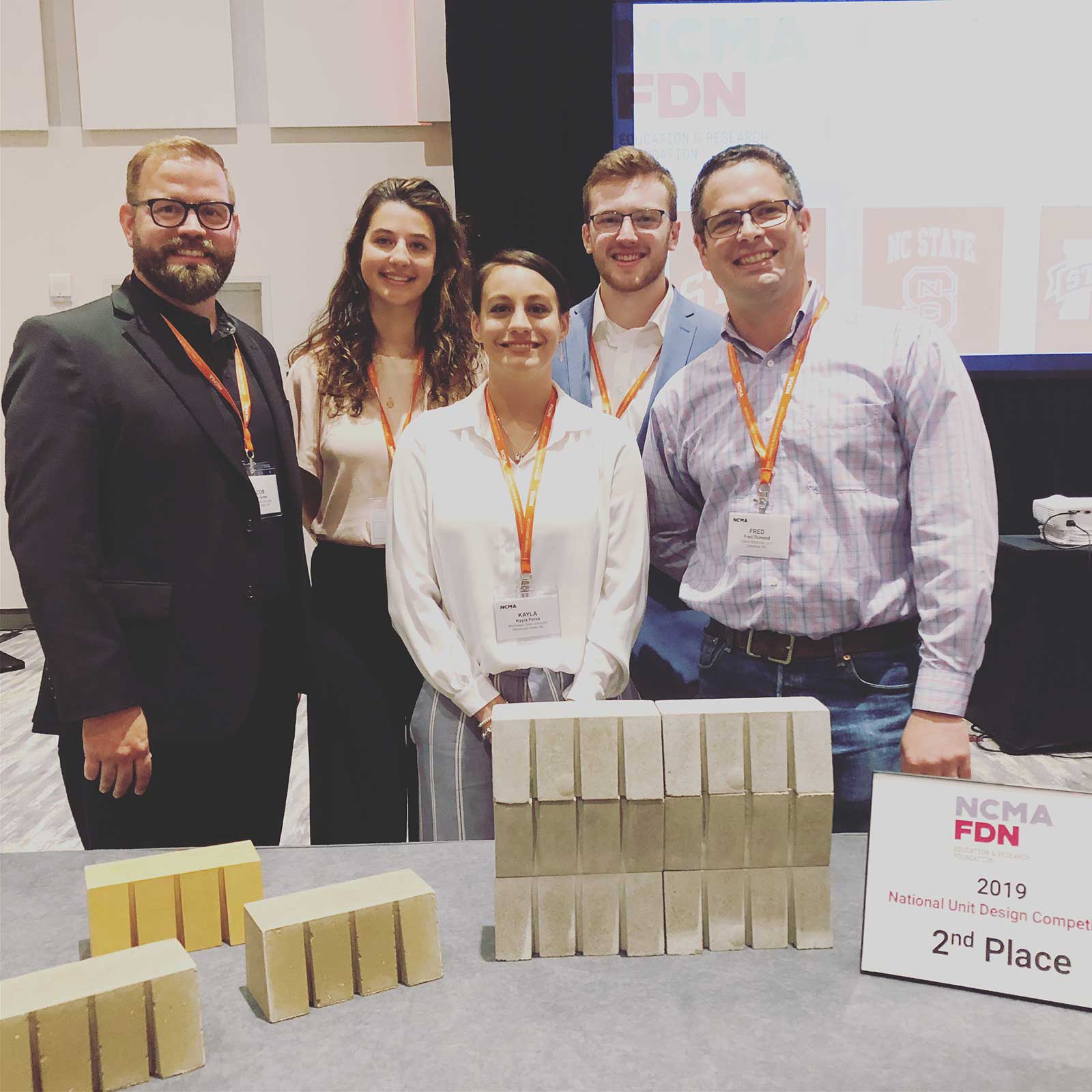 Pictured at the National Concrete Masonry Association 2019 Midyear Meeting in Seattle, Washington, are (left to right) MSU Associate Professor of Architecture Jacob A. Gines; MSU architecture juniors Grace Sheridan, Kayla Perez and Joseph Thompson; and Fred Dunand, president of Saturn Materials LLC of Columbus, sponsor of the local Unit Design Competition. 