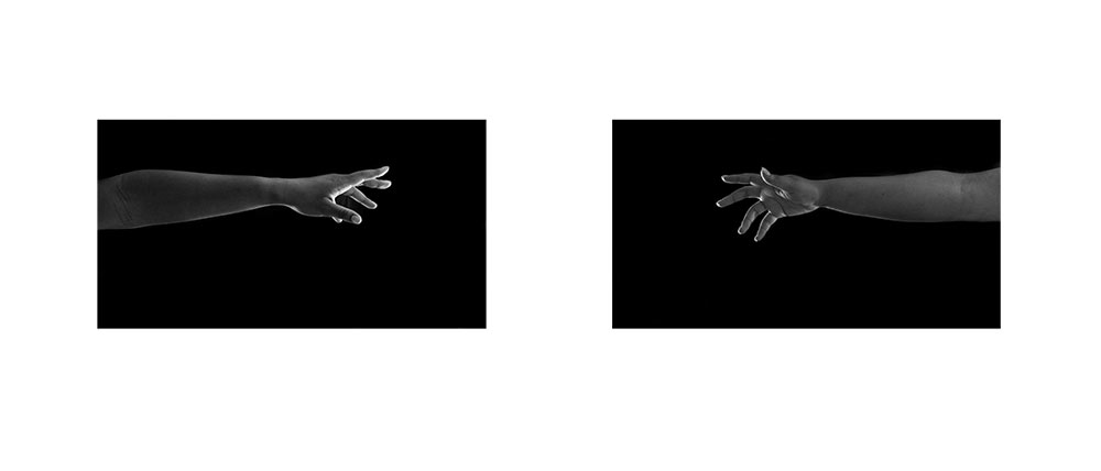 two black and white images of hands reaching for each other toward center