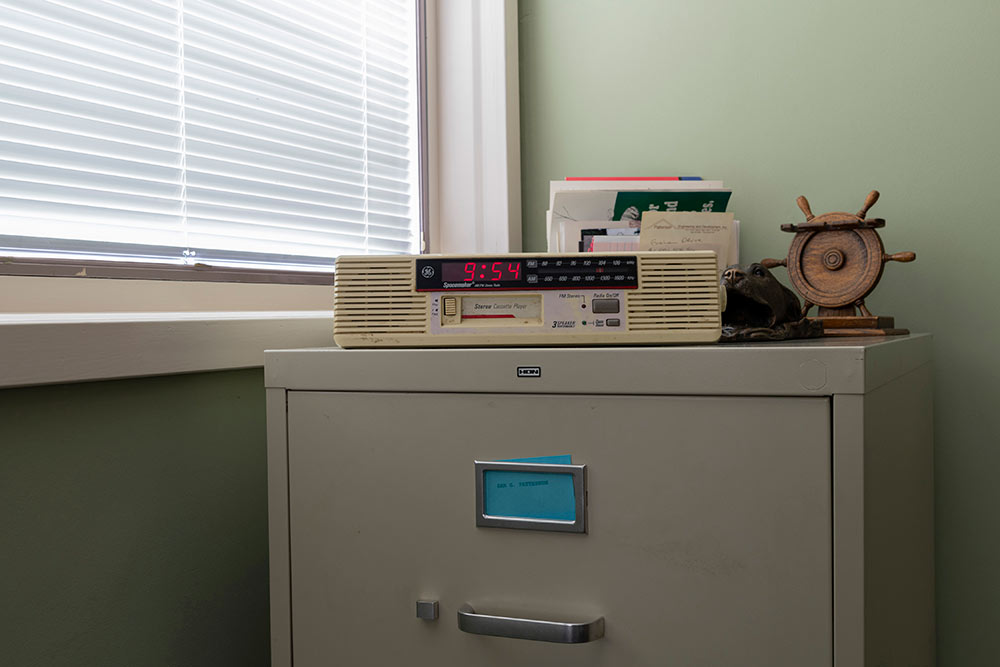 view on top of filing cabinet. digital clock displays 9:54