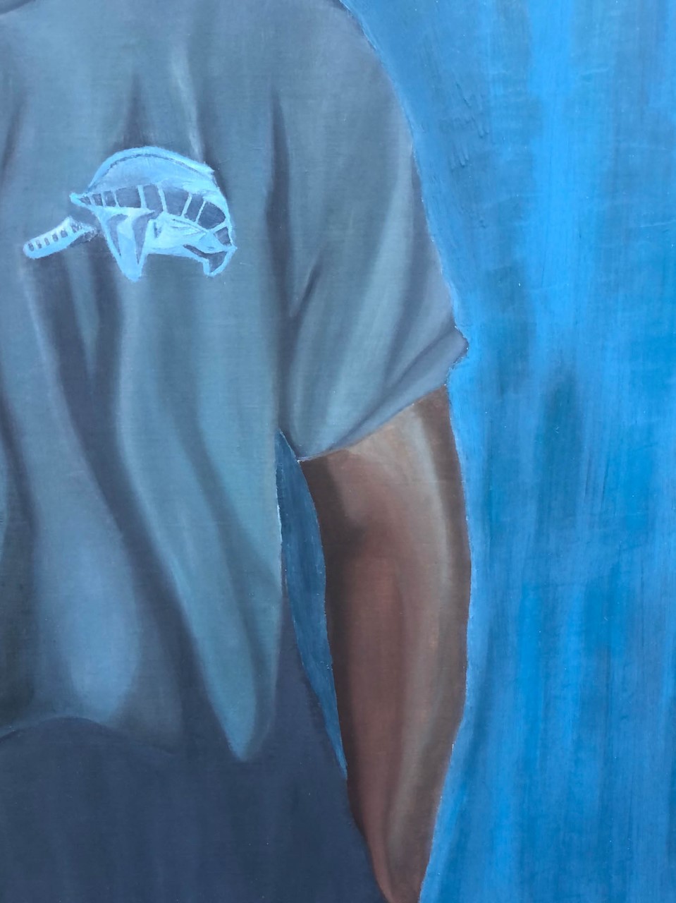 Detailed and textural image of specific and layered brush stroke on the male figure’s right arm and hand. Multiple cool toned and dark toned areas of browns and blues on both the right arm and hand.