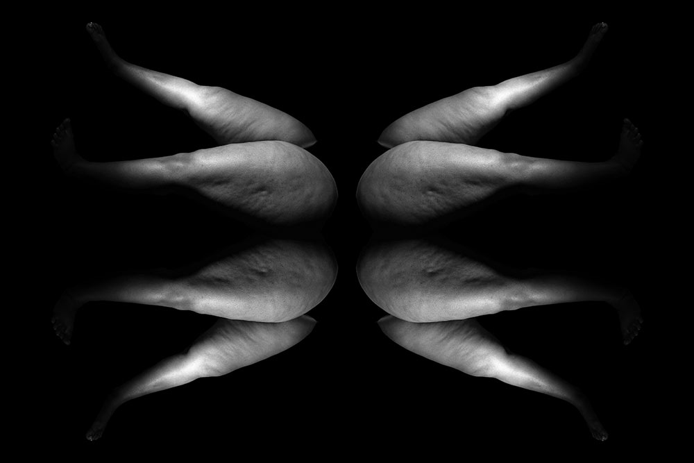 black and white image of legs repeated in a wing pattern