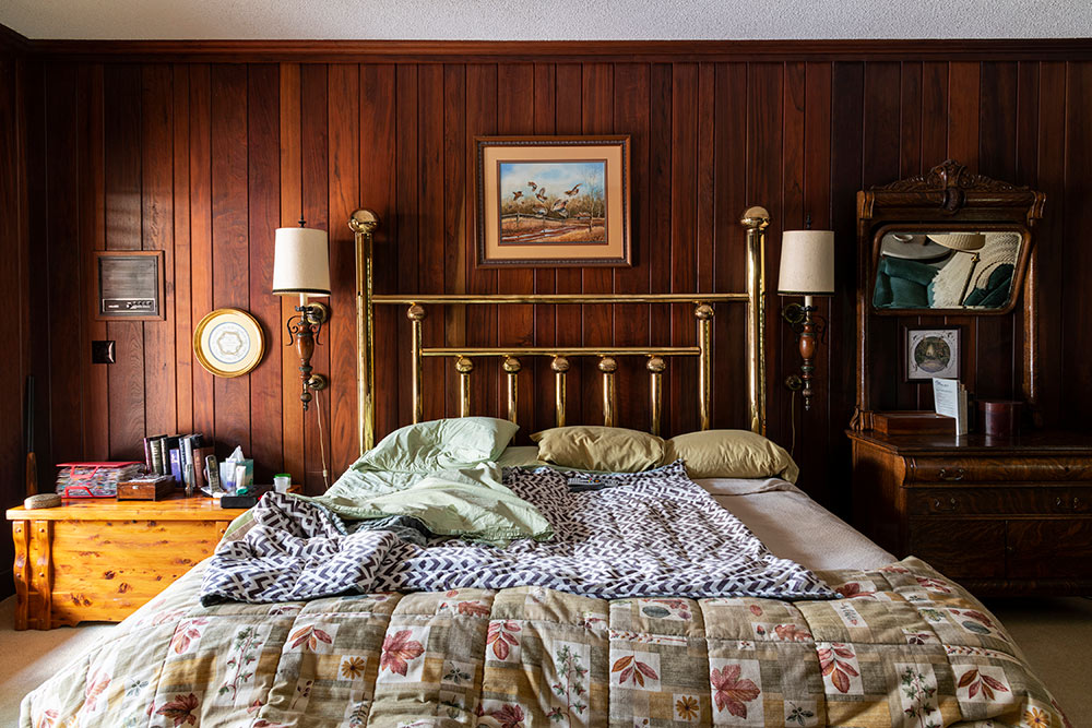 view from foot of bed showing bed and back wall