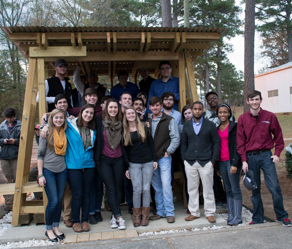 Group shot of students in front of completed structure.