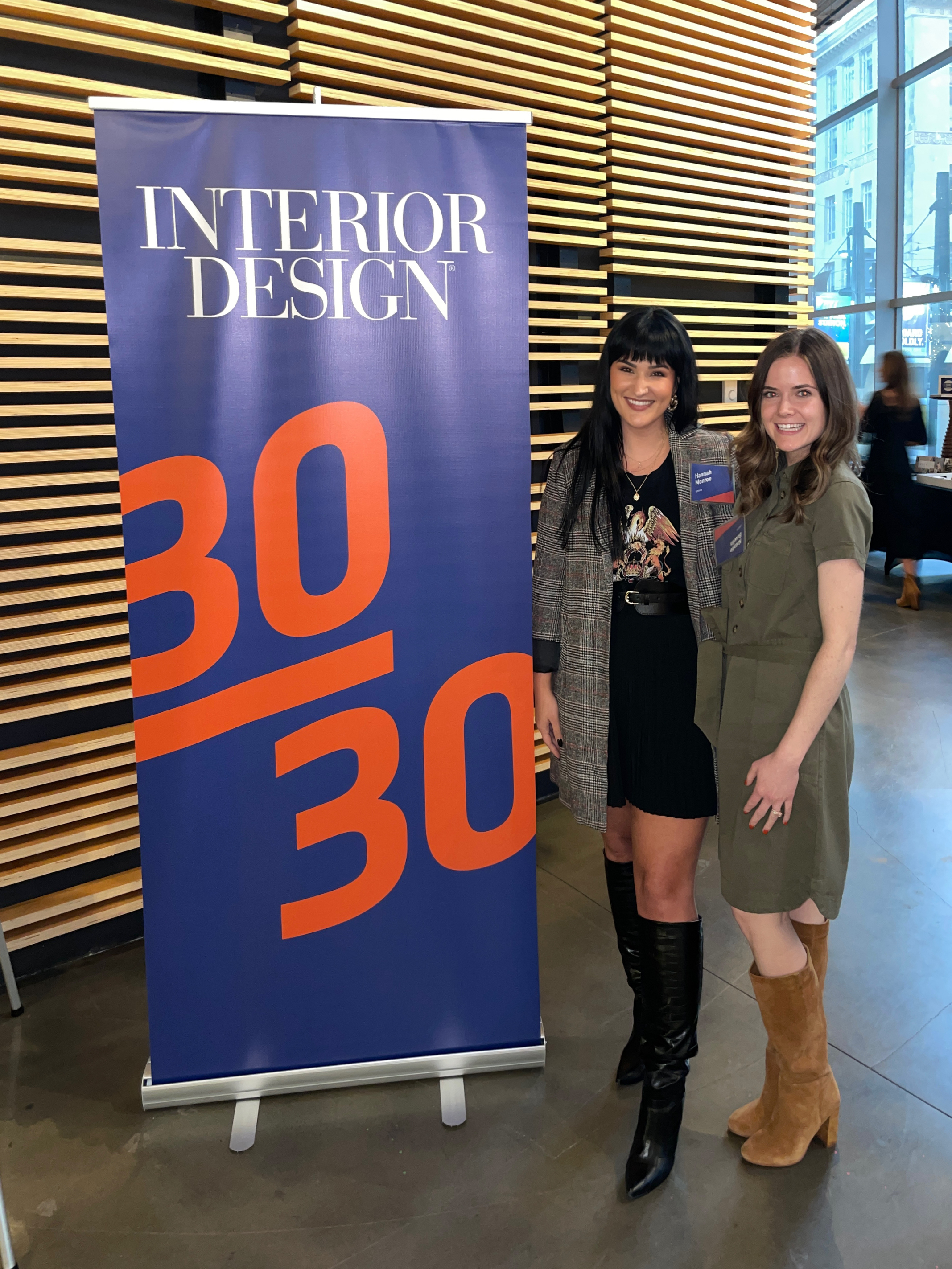 Hannah Monroe, left, stands with Natalie Bowlin next to Interior Design Magazine's 30/30 Program sign