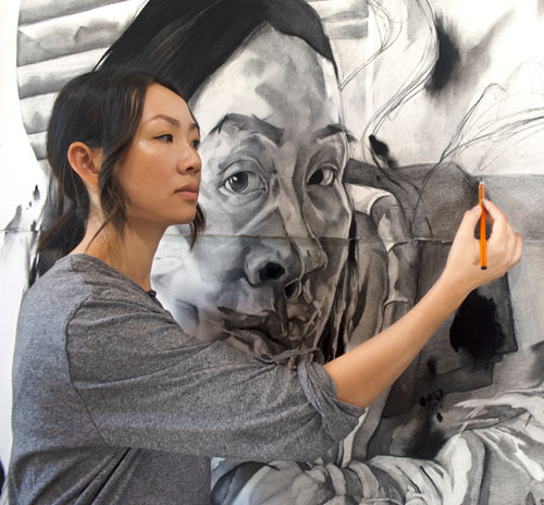 Ming Ying Hong drawing large person on wall