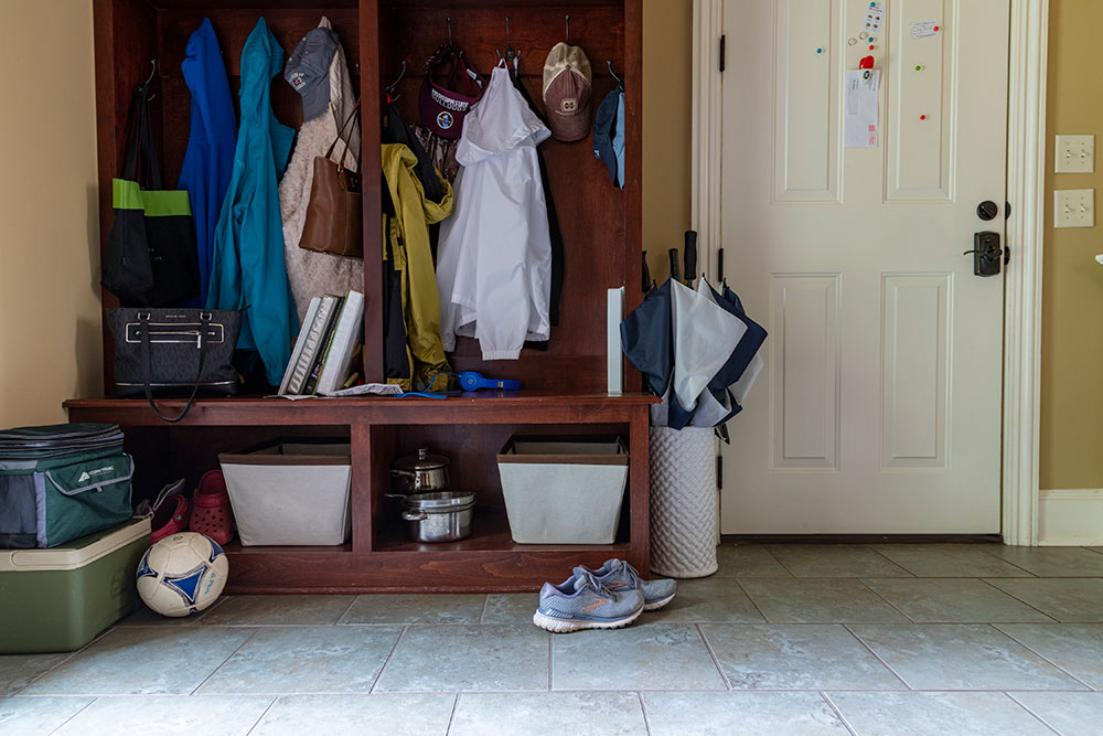 view of mud room with jackets, shoes, soccer ball