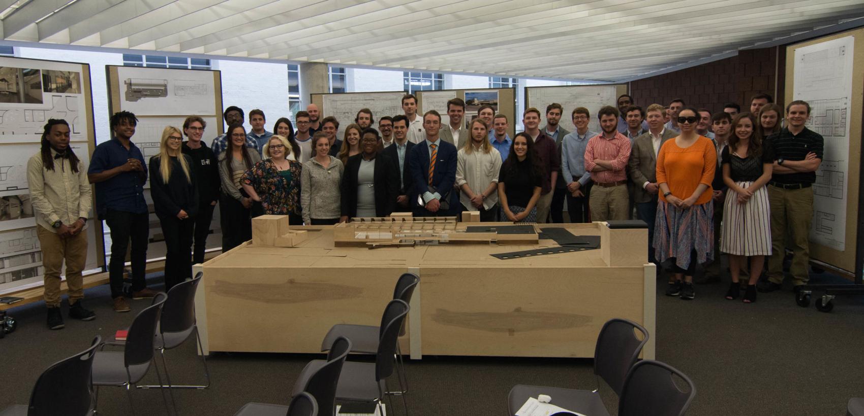 Provided by Mitchel Marshall Mitchel Marshall, center with orange tie, stands with MSU students following their presentations about the building.