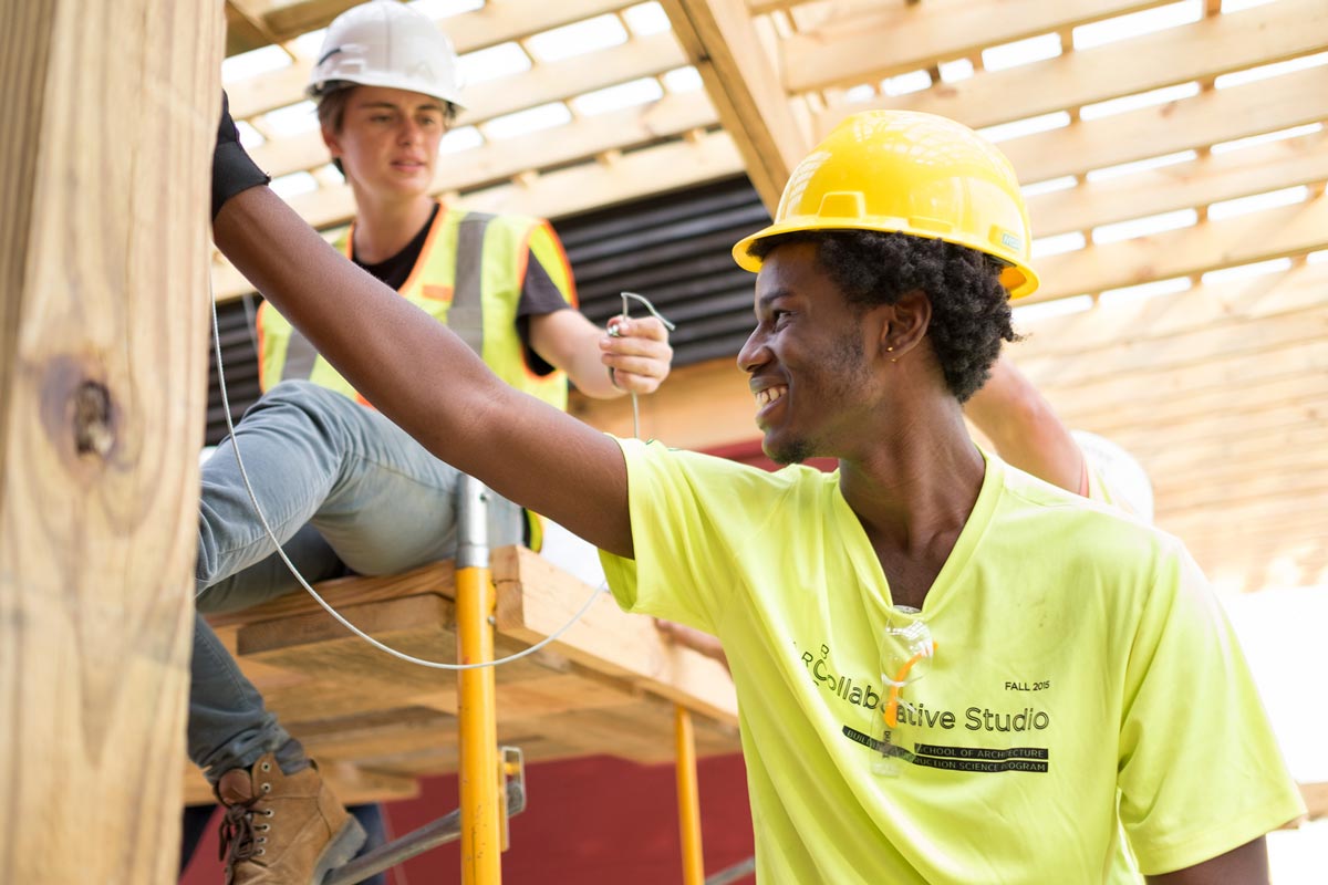 Students helping with construction of building