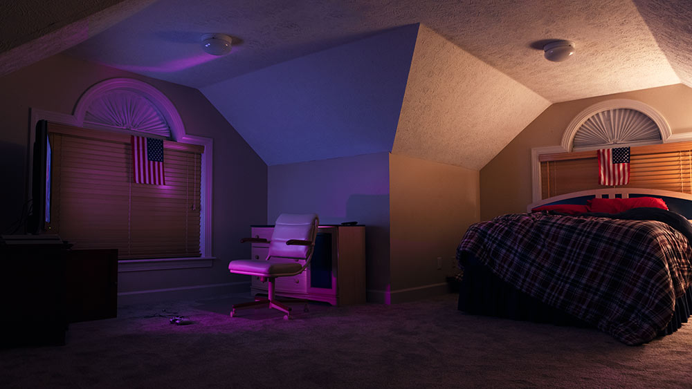 dark bedroom with pink light cast