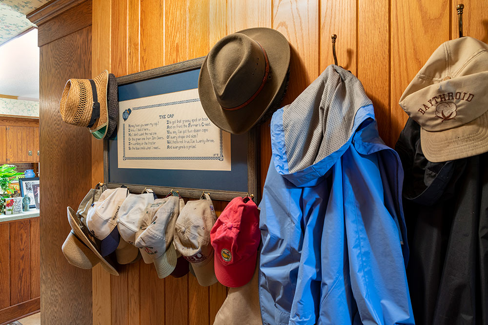 view of hats and coats hanging on wall