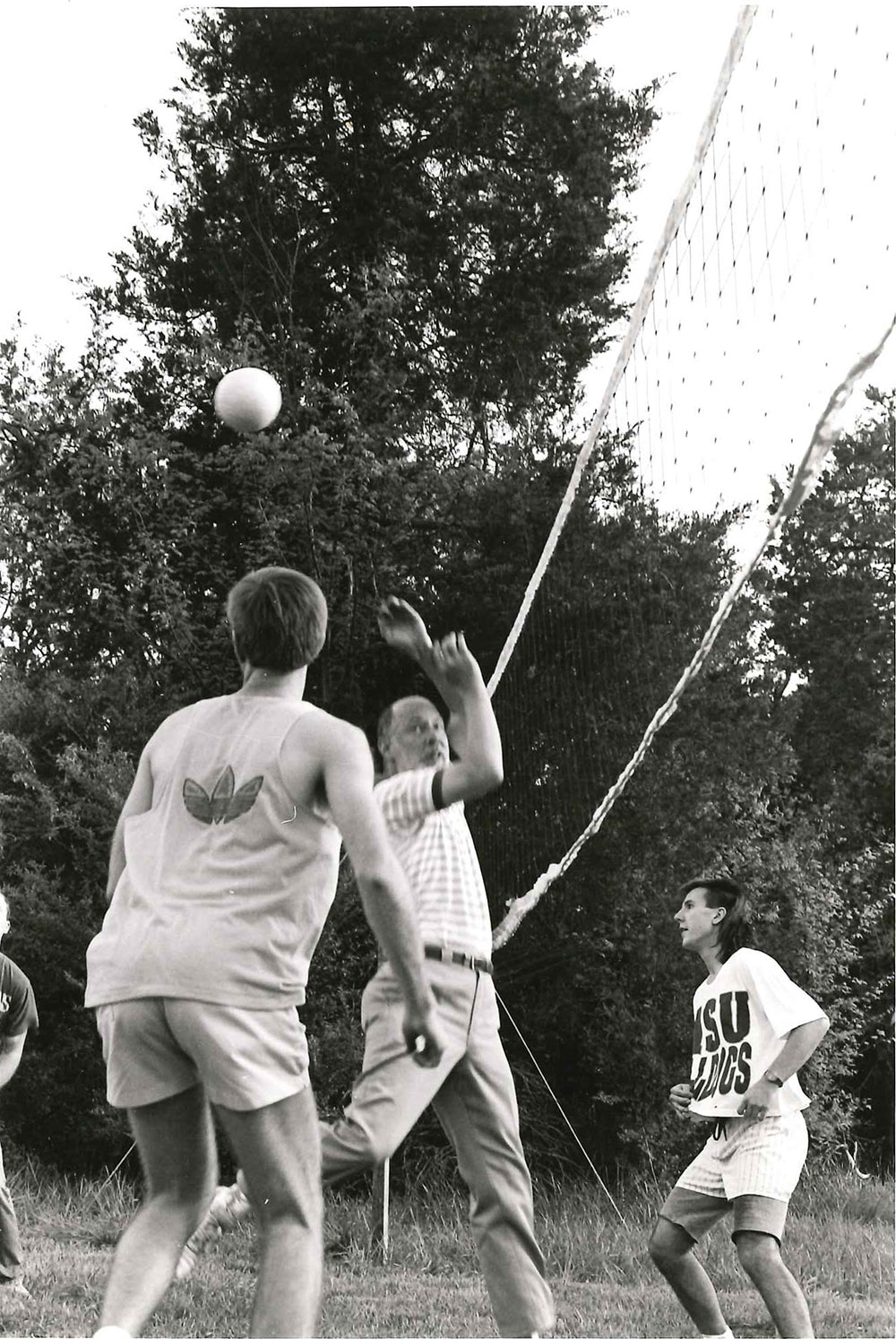 Dr. Michael Fazio, center, plays volleyball with two others