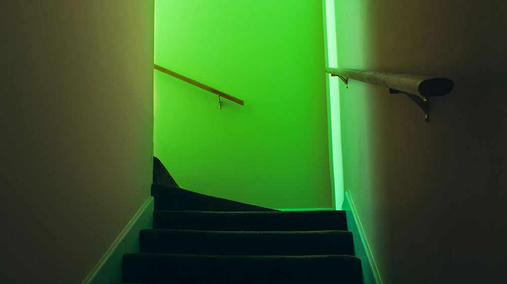 stairway leading up to green light