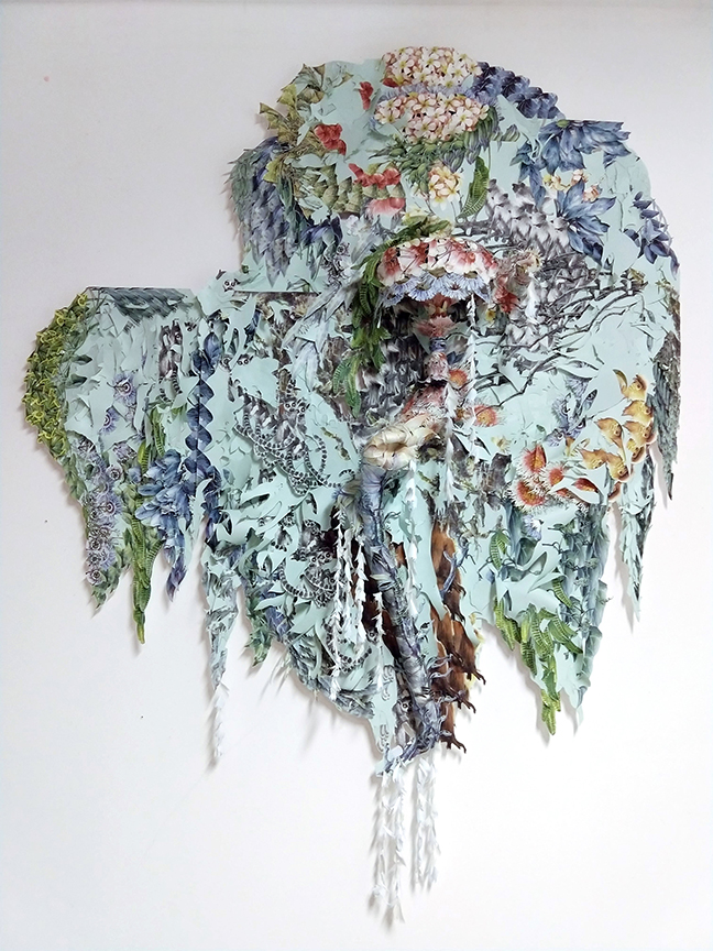Artwork by Elizabeth Alexander made from green wallpaper with lemurs and flowers hanging on a white wall
