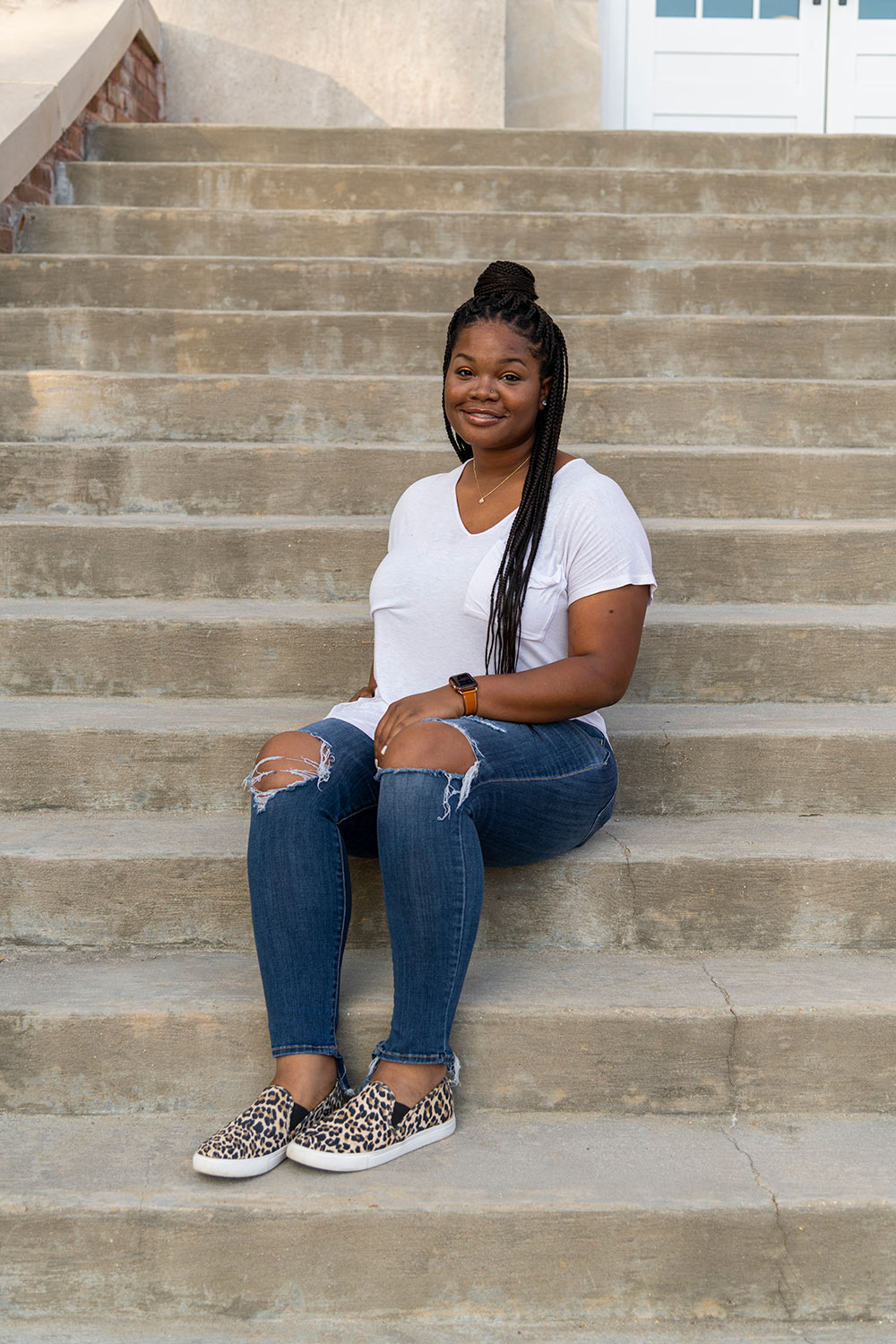 Alexandria Johnson sits on steps