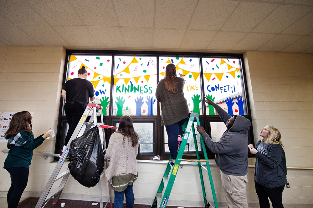 Art Department students outreach at Sudduth Elementary, installing their final project for Design I, a class taught by graphic design lecturer Brittany Spencer.
 (photo by Megan Bean / © Mississippi State University)