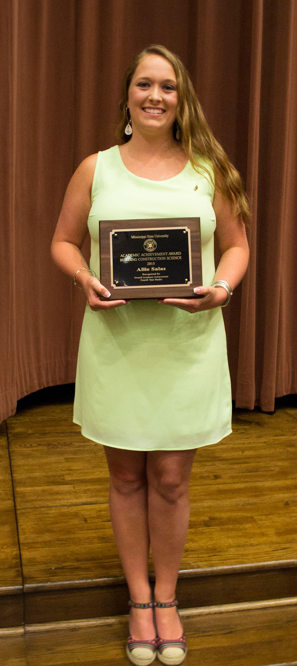 Allie Salas holds award