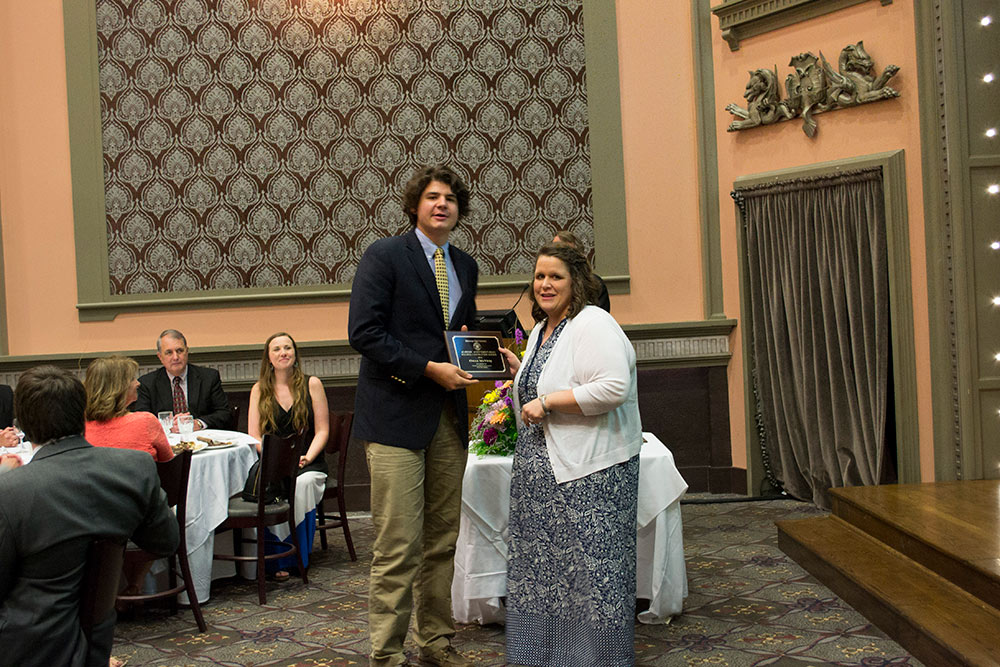 Owen McVitty, left, receives award from Laura Mitchell