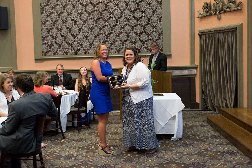 Allie Salas, left, accepts award from Laura Mitchell