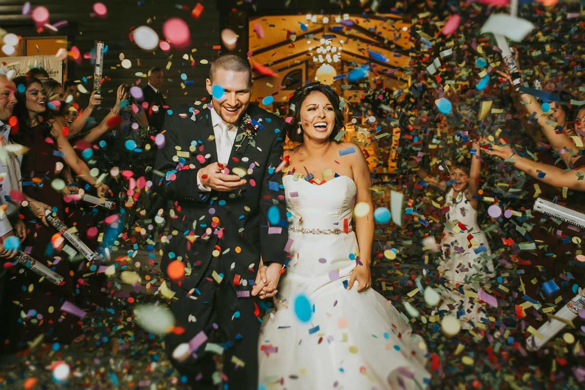 Wedding photo of bride and groom with confetti 