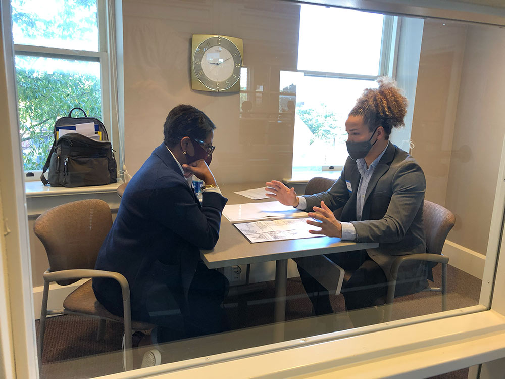 Architecture student Jared Woullard, right, in a mock interview in Montgomery Hall during the Professional Horizons Workshop