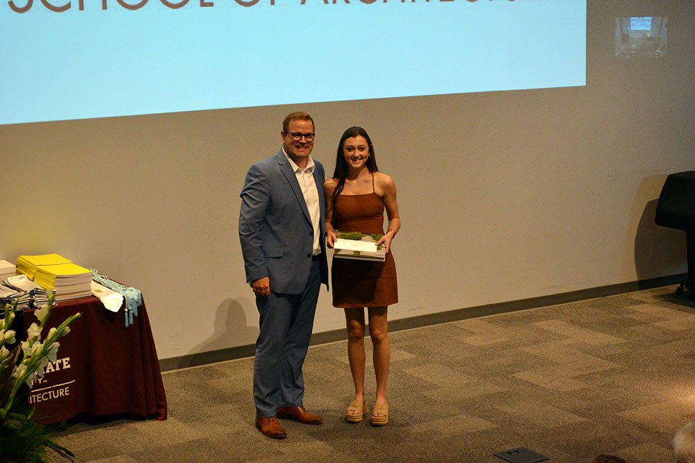 Nicole Columbus, right, poses with Professor Jake Gines