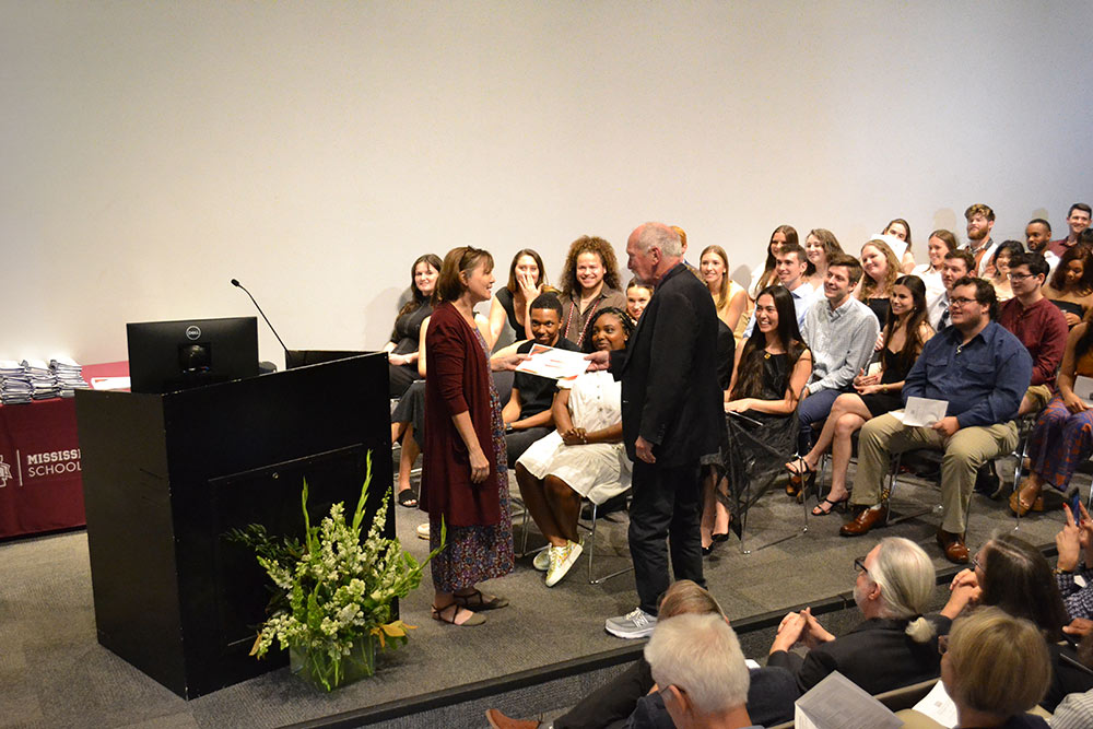 Karen Spence, left, awards David Buege with the Allen & Hoshall Faculty Award