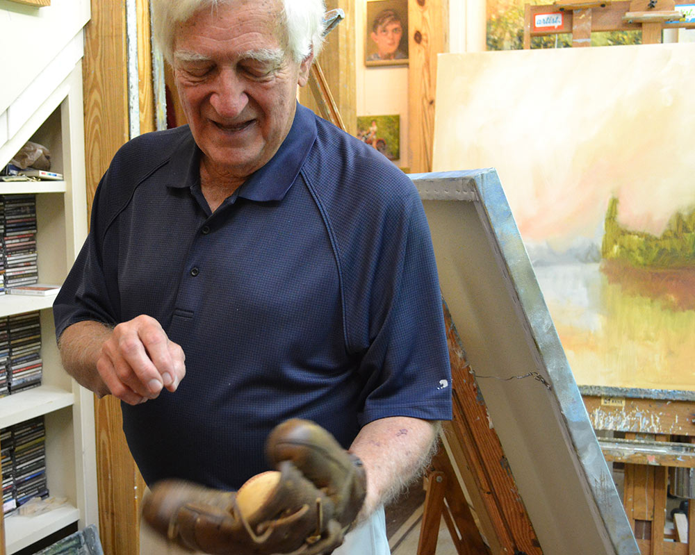 Dr. Charles Guess shows off his childhood baseball glove.