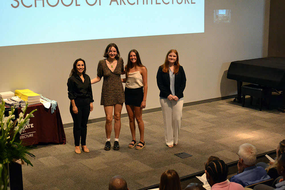 Professor Silvina Lopez Barrera stands with the three first-year faculty book award recipients